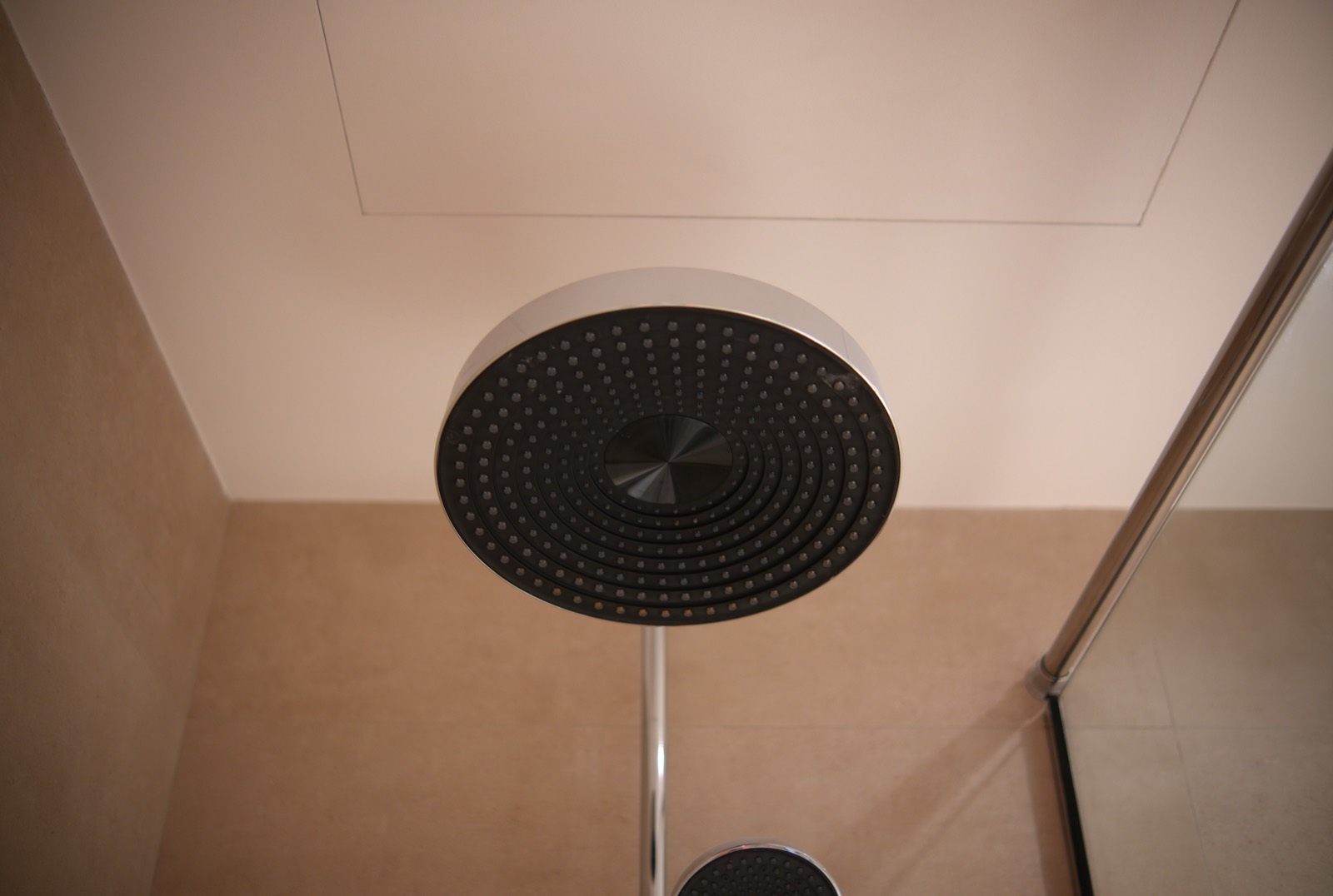 Sculptural circular LED pendant light over an open-plan living space
