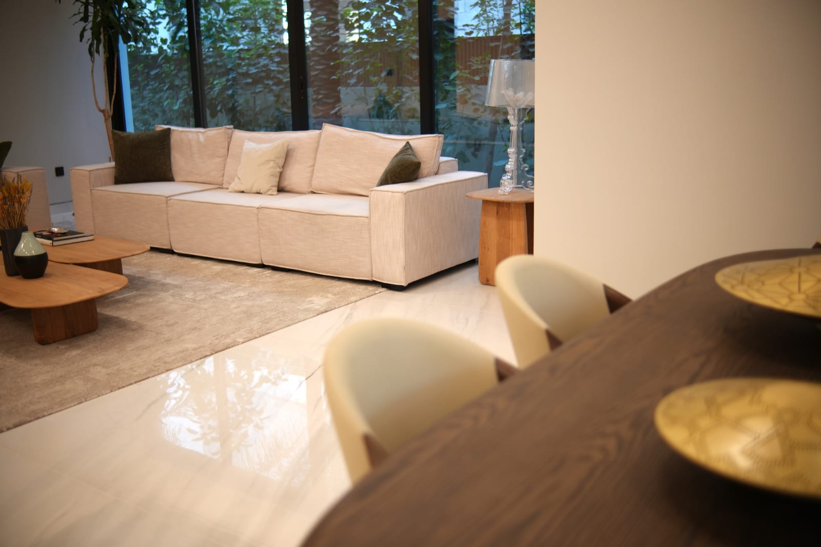 Double-height living and dining space in a twin villa project in Meydan, Dubai