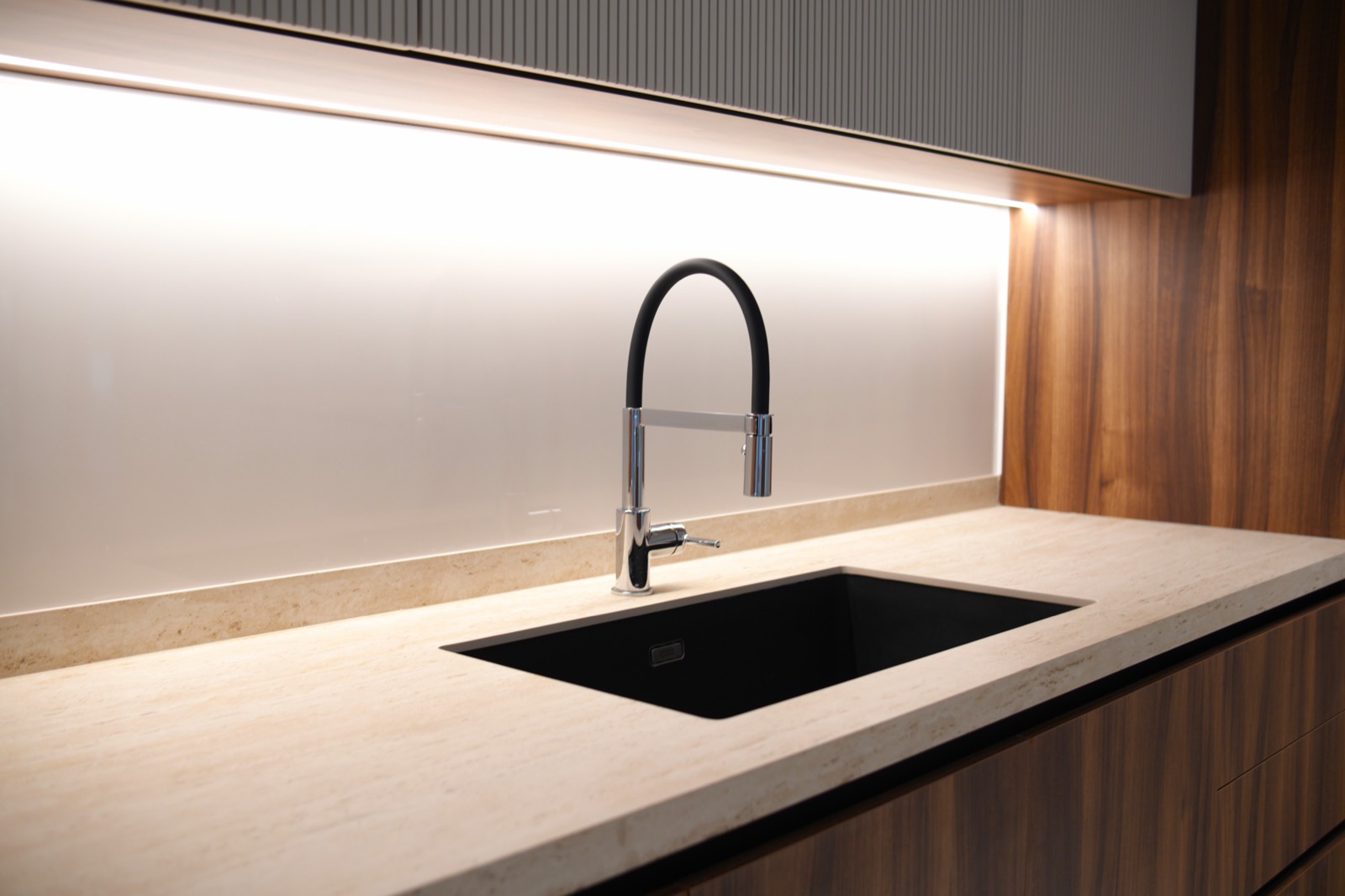 Travertine kitchen counter with black undermount sink and designer tapware